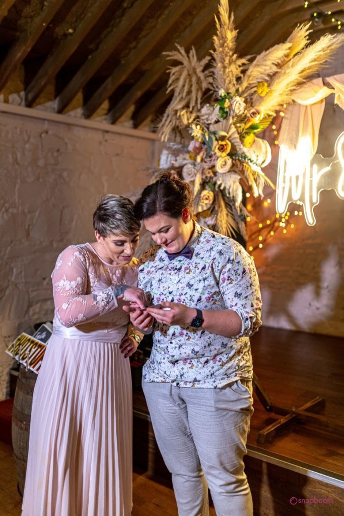 two women looking at their printed photo