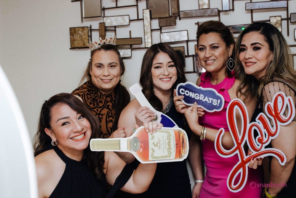 five girls with props using the selfie pod
