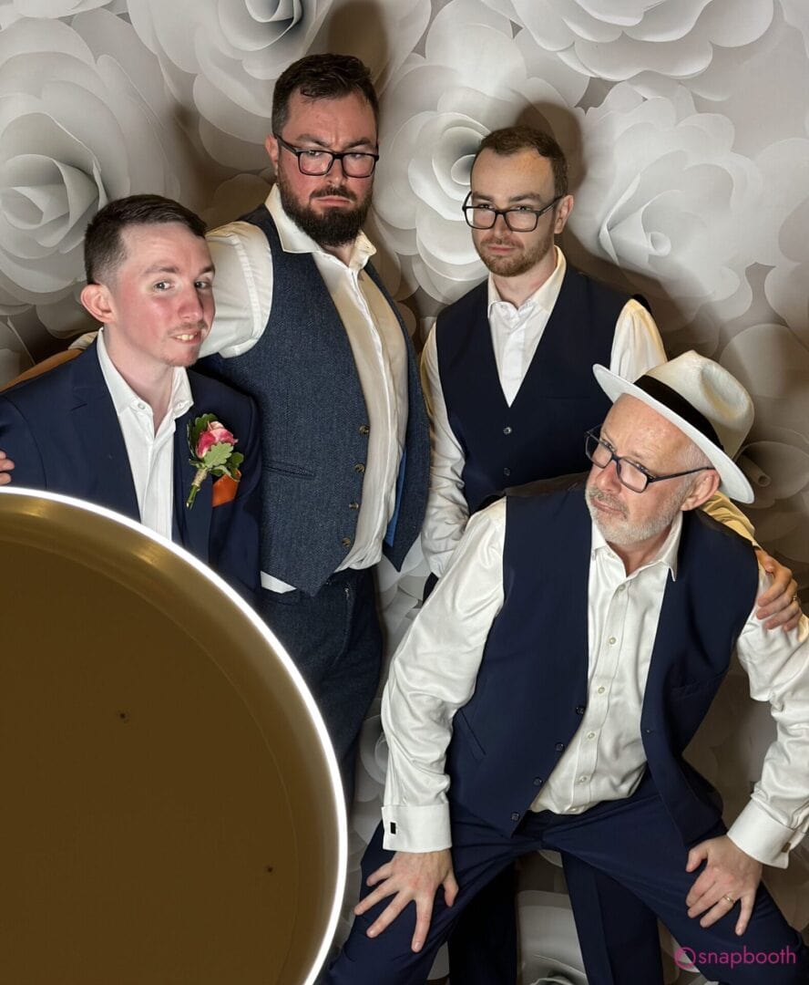 Groomsmen posing together in a photo booth at a Cowley wedding