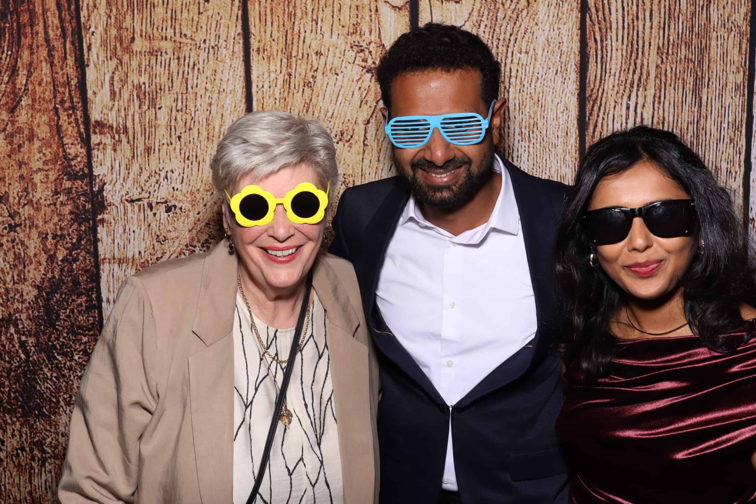 Prom photo booth hire - guests of different ages wearing novelty glasses