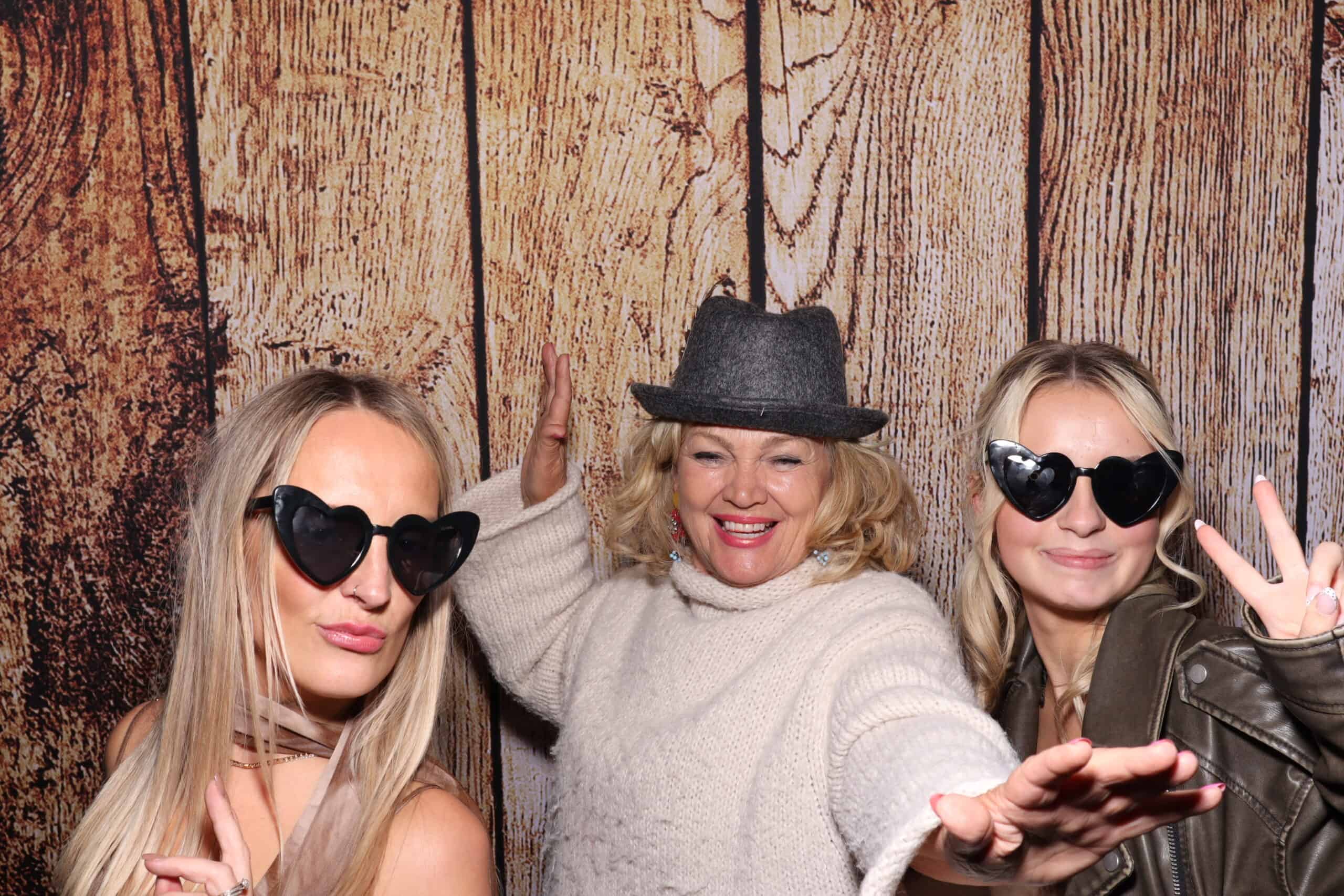 Birthday photo booth hire - women posing glamorously with heart sunglasses