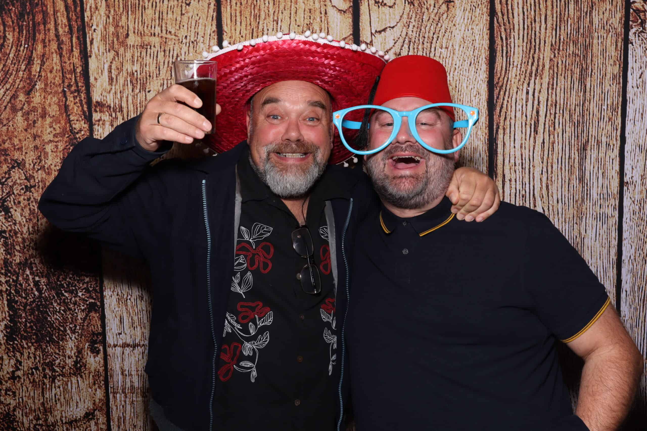 Friends celebrating with sombrero and fez hat at Snap Booth photo booth hire