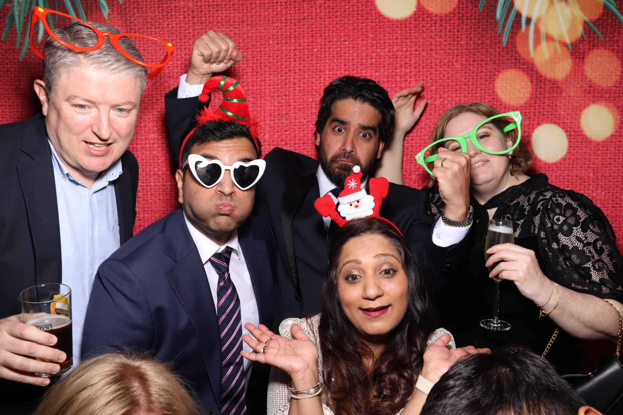 Corporate Christmas photo booth hire with oversized festive glasses